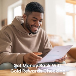 Young man holding paper smiling with text "Get money back with Gold Rewards Checking"