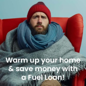 Man sitting, wearing hat, under blanket. "Warm up your home & save money with a fuel loan."